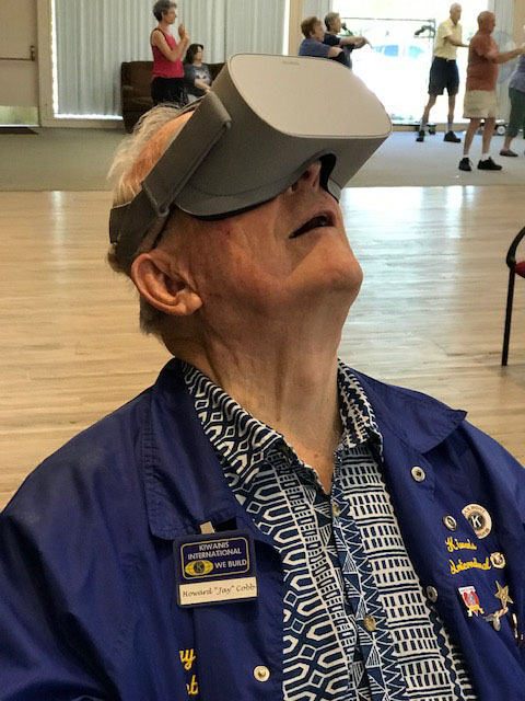 Jay Cobb tests a virtual reality headset at a library outreach program with the Kiwanis Club of Oakmont on July 18, 2019. Photo by Bridget Hayes