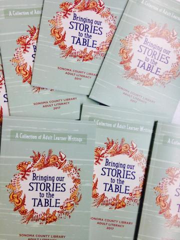 pile of books with title text "bringing our stories to the table"